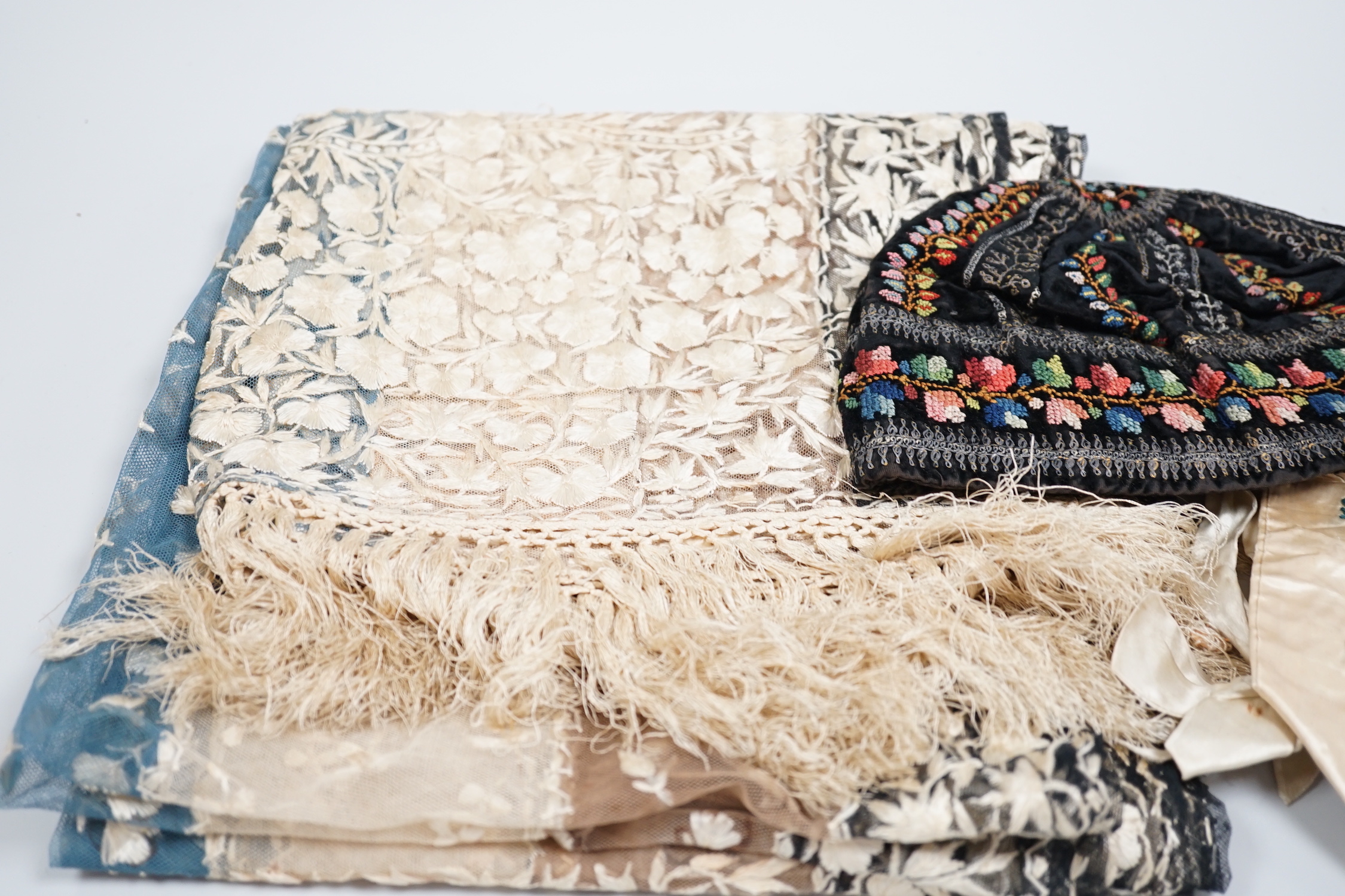 A 19th century Indian net embroidered silk floss stole, a black velvet silk cross stitch embroidered hat and a cream satin ribbon worked ladies bag, stole 240cm long, 57cm wide